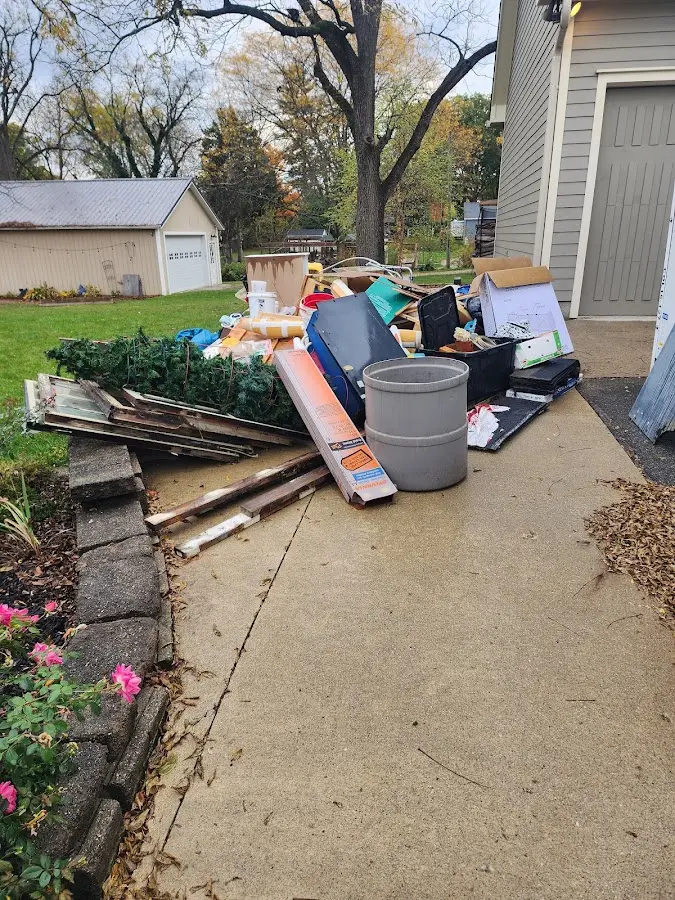 Dumpster being loaded with debris for Estate Cleanout Dumpster Rental in Princeton